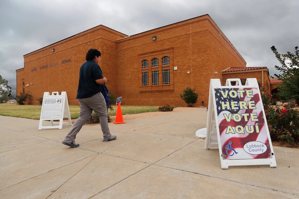 A voter walks past an election sign on his way to vote outside of the Lauro Cavazos Middle School polling station in Lubbock, Texas, on Tuesday, Nov. 8, 2022. Department of Homeland Security officials this week told the Lubbock County elections administrator to expect subpoenas for county voter records soon.